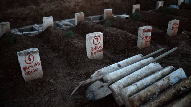 Graves of Kurds killed fighting in Kobane. The US claims it has killed hundreds of Islamic State fighters with its air strikes.