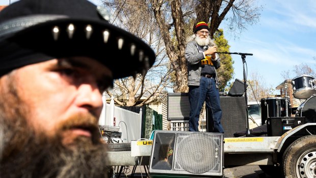 Aboriginal elder Larry Walsh, pictured at the microphone on a truck, called on squatters at the Bendigo Street Festival in Collingwood on Sunday to fight for a more permanent solution to homelessness, particularly among Indigenous people. 