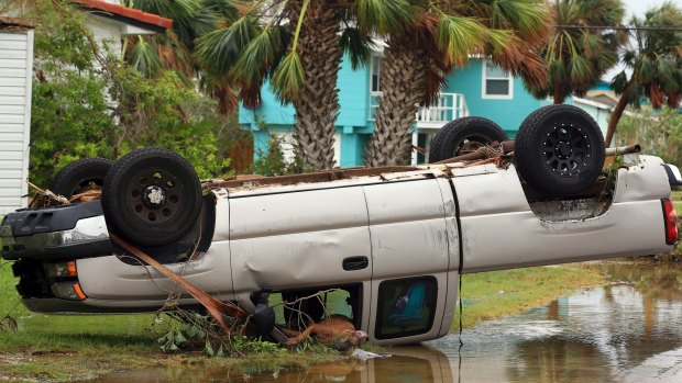A truck is flipped over after Hurricane Harvey landed in the Coast Bend area on Saturday.