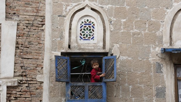 A boy looks out from the window of his house in the Old City in Sanaa, Yemen, earlier this month. 