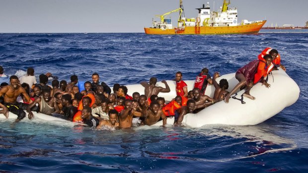 Migrants ask for help from a dinghy in the Mediterranean.