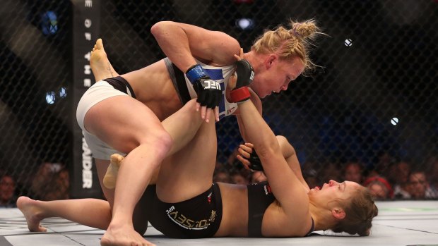 Holly Holm takes it to previously undefeated champion Ronda Rousey in Melbourne.