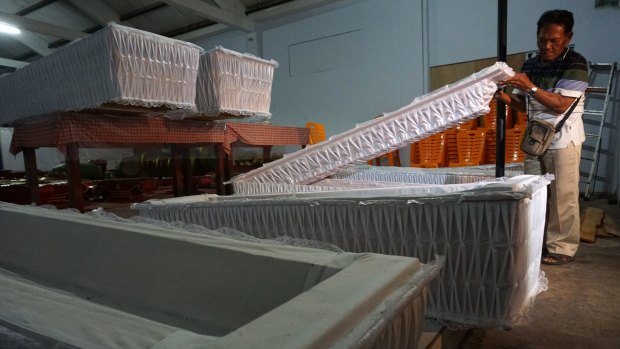 Nine coffins are delivered to the police station in Cilacap on Sunday.