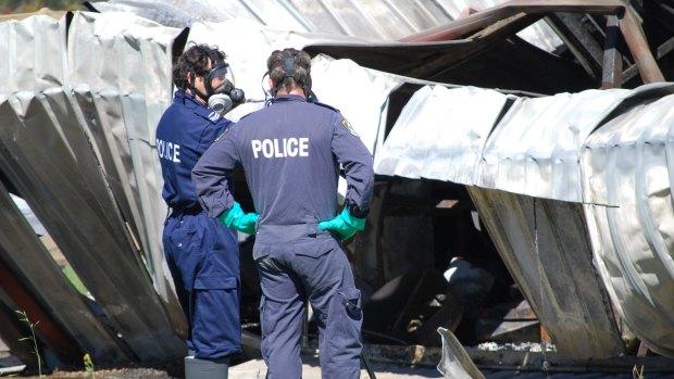 Police inspect the damaged shed after the fatal blast in October, 2010.