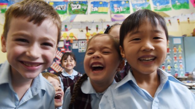 Kindergarten students enjoying a laugh. A child disinclined to join in could have signs of psychopathic traits. 