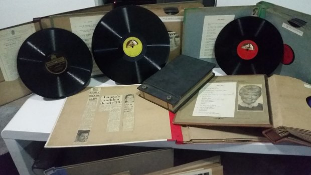 The records are accompanied by newspaper clippings about the recording artists.