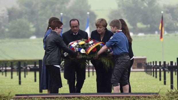 French President Francois Hollande and German Chancellor Angela Merkel lay a wreath at Consenvoye.