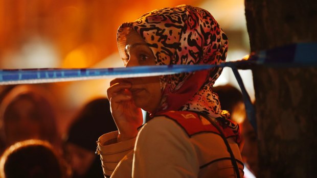 A woman watches behind a police line at the scene of a blast in Istanbul on Thursday.