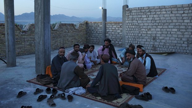 Men meet on the roof of a teahouse, one of the few modern buildings in Tarin Kowt.