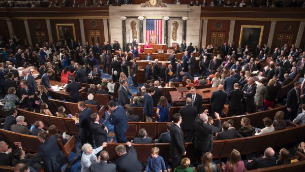 Members of the House of Representatives, some joined by family, gather as the 115th Congress gets under way in Washington on Tuesday.