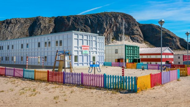 A school building and fenced schoolyard in Kangerlussuaq, a small town in western Greenland.
