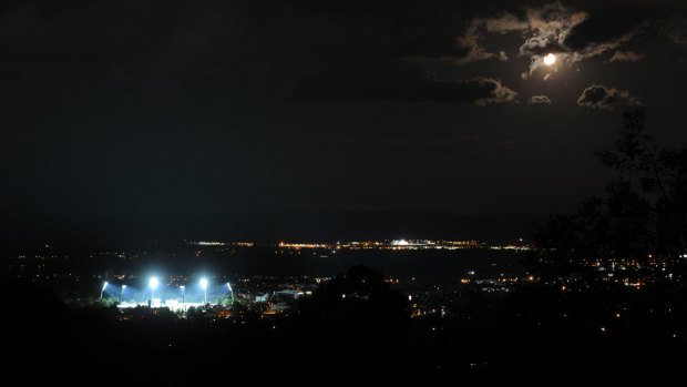 Manuka Oval lit up for the first day/night Prime minister's XI match against the West Indies in 2013.