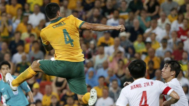 High times: Tim Cahill leaps to score against China in the Asian Cup.