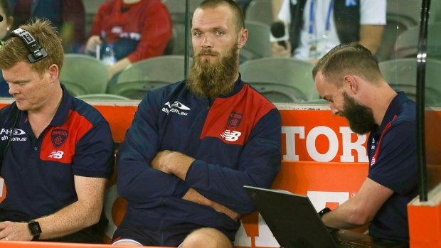 Demons ruckman Max Gawn wathces miserably from the bench at Etihad after leaving the field injured.