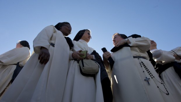 Nuns wait for Pope Francis' arrival on Sunday.
