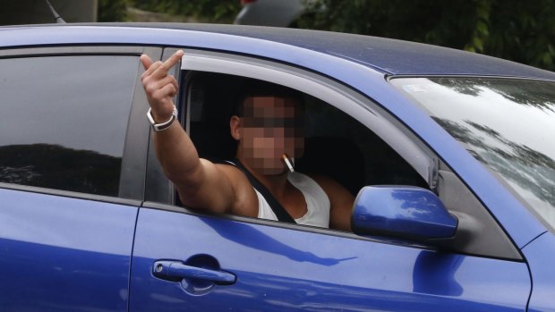 A man at the Wentworthville raid gestures to the media on Wednesday.