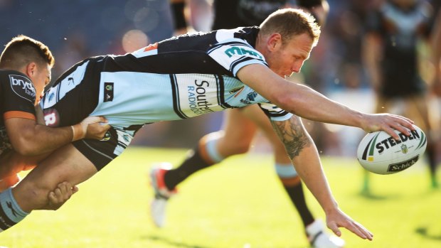 Full stretch: Luke Lewis of the Sharks reaches out to score a try.