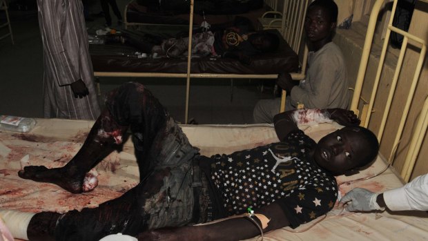 The injured receive treatment at a local hospital following an explosion at a mobile phone market in Kano, Nigeria on Wednesday.