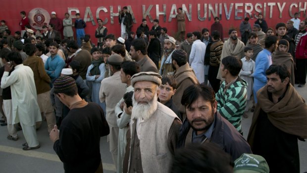 Students' family members stand outside Bacha Khan University.