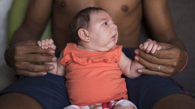 Dejailson Arruda holds his daughter Luiza at their house in Santa Cruz do Capibaribe, Brazil. Luiza was born in October with microcephaly, her mother was infected with the Zika virus.