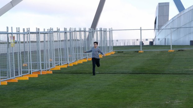 A temporary fence is installed at Parliament House in preparation for the building of a permanent security fence. 