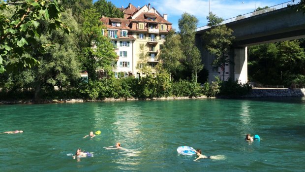Swimmers make the most of the Aare River whenever the sun shines in Bern.