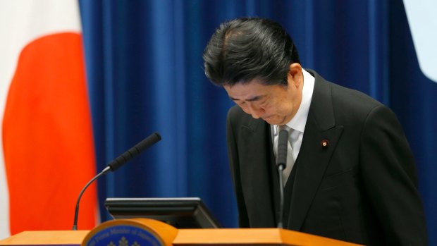 Japanese Prime Minister Shinzo Abe bows during a press conference after reshuffling his Cabinet on Thursday.
