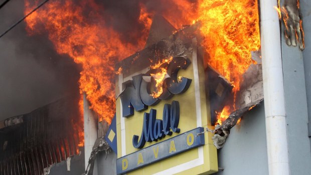 A fire rages on at a shopping mall in Davao on Saturday.