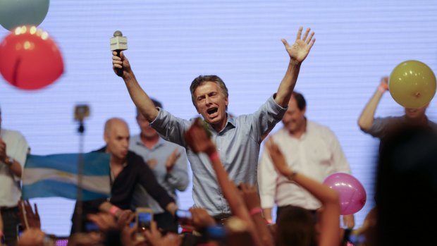 Opposition presidential candidate Mauricio Macri celebrates with supporters at his campaign headquarters in Buenos Aires, Argentina, on Sunday.