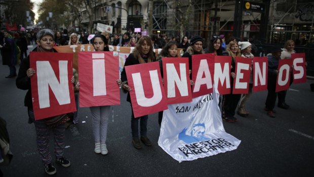Demonstrators hold placards with a phrase that reads in English "not even one less" during a march against domestic violence in Buenos Aires last week.