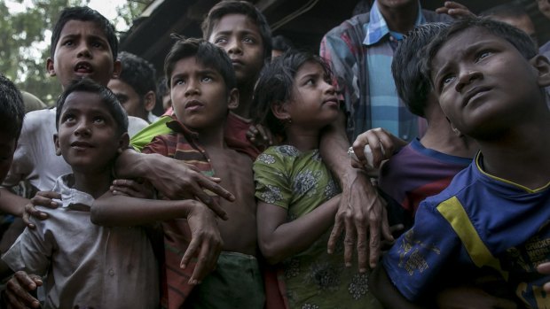 Rohingya refugees gather to receive relief supplies donated in the Leda Rohingya refugee camp in Chittagong, Bangladesh.