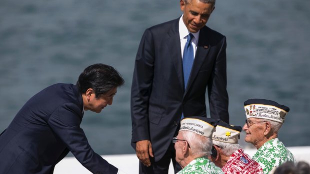 Japanese PM Shinzo Abe, left, and US President Barack Obama speak with Pearl Harbor veterans, from left, Sterling Cale, Al Rodrigues and Everett Hyland in Honolulu. 