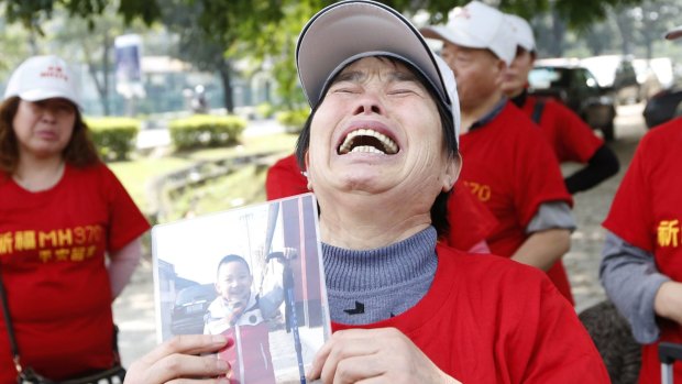 Wang Run Xiang holds a picture of her grandson, whose father was aboard Malaysia Airlines Flight MH370 when it disappeared.