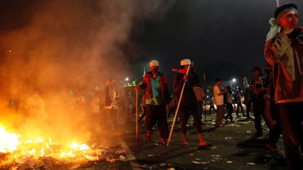 Protesters near a fire during the protests in Jakarta. 