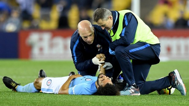 Crocked: Team medics attend to Melbourne City's Osama Malik during the round two derby win over Victory.