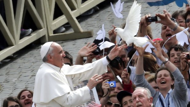Taking a stand on the environment ... Pope Francis holds a dove before his general audience at San Peter's Square at the Vatican on Wednesday.