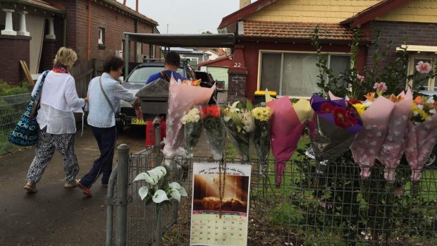 Bouquets of flowers line the fence of the Chans' house in Enfield as Michael and Helen Chan arrive home from Indonesia.