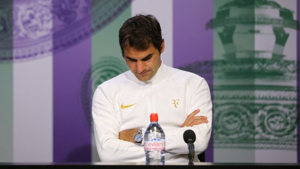 Roger Federer speaks to the media following his defeat to Milos Raonic.