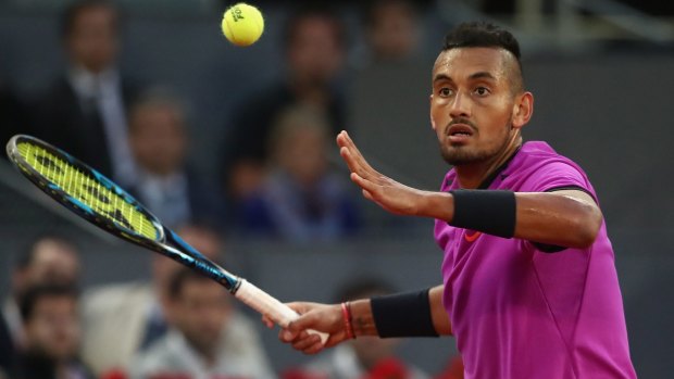 Outgunned: Nick Kyrgios plays a forehand back to Rafael Nadal.