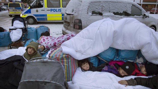 Migrant children from Syria sleep outside the Swedish Migration Board, in Marsta, Sweden, last month. 