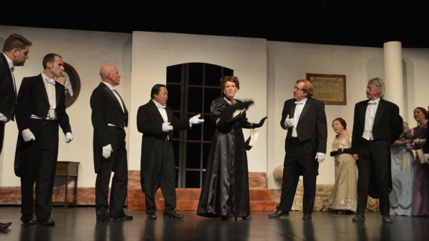Louise Keast, centre,  as the Widow at an embassy reception in <i>The Merry Widow From Bluegum Creek</i>.