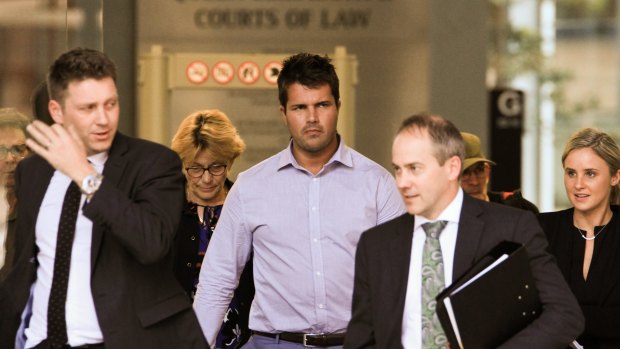 Accused killer Gable Tostee, centre, leaves the Supreme Court in Brisbane with defence barrister Saul Holt, right.