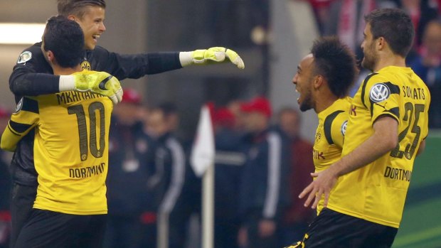 Dortmund's hero: Mitch Langerak is mobbed by teammates following the penalty shootout win.