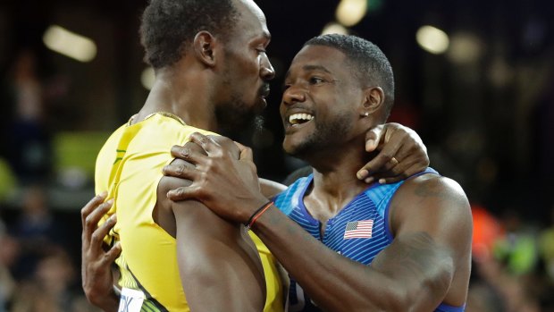 Gold medal winner Justin Gatlin (right) embraces Jamaica's Usain Bolt.