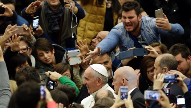 Pope Francis is cheered by youths as he leaves an audience with workers and volunteers of the  Policoro Project, a Catholic initiative to fight high juvenile unemployment rates in Italy.