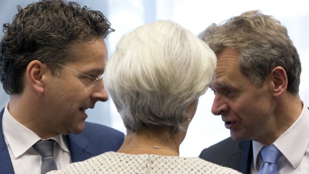 International Monetary Fund chief Christine Lagarde, centre, speaks with Dutch Finance Minister  Jeroen Dijsselbloem, left, and  the IMF's European director Poul Thomsen during the meeting of eurozone finance ministers in Brussels on Saturday.