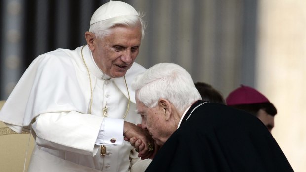 Cardinal Bernard Law, right, kisses Pope Benedict XVI's hand in 2006.