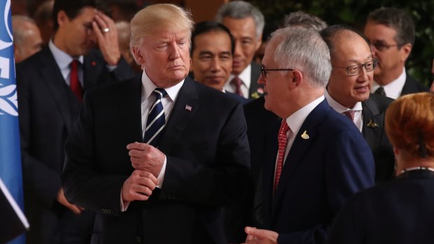 Australian Prime Minister Malcolm Turnbull walks with US President Donald Trump to the G20 family photo.