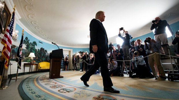 US President Donald Trump exits the Diplomatic Reception Room in the White House in October, after announcing that he would not certify Iran's compliance with the nuclear deal negotiated by his predecessor, Barack Obama.