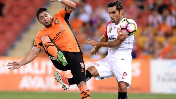 Full-blooded affair: Dimitri Petratos of the Roar is fouled by Dimas Delgado.